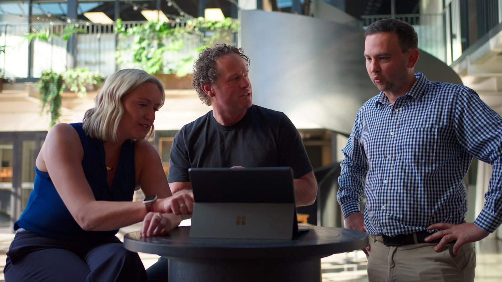Mell, Matt and JP gathered around a laptop