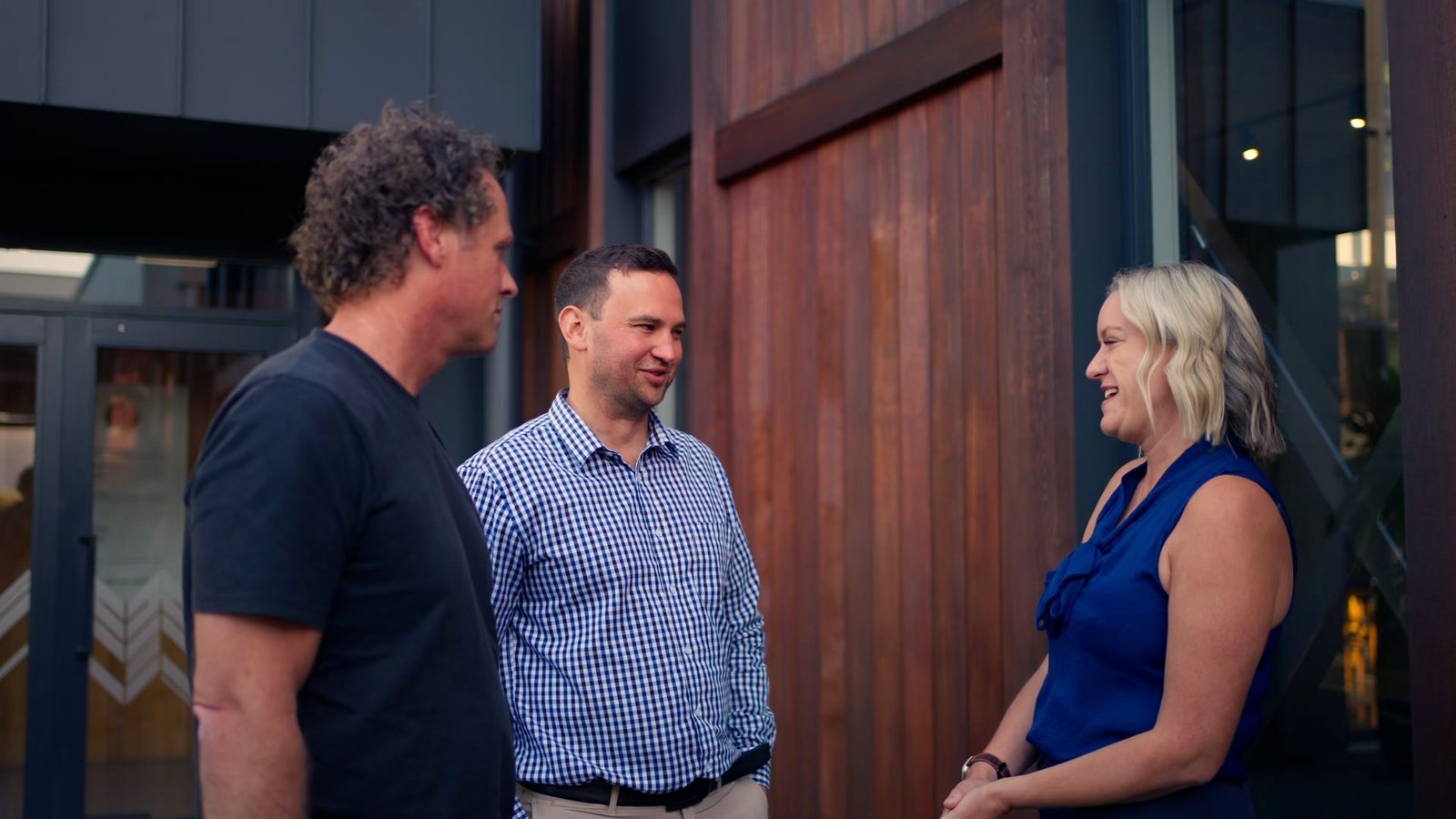 Matt, a client and Mell sharing a laugh outside an office