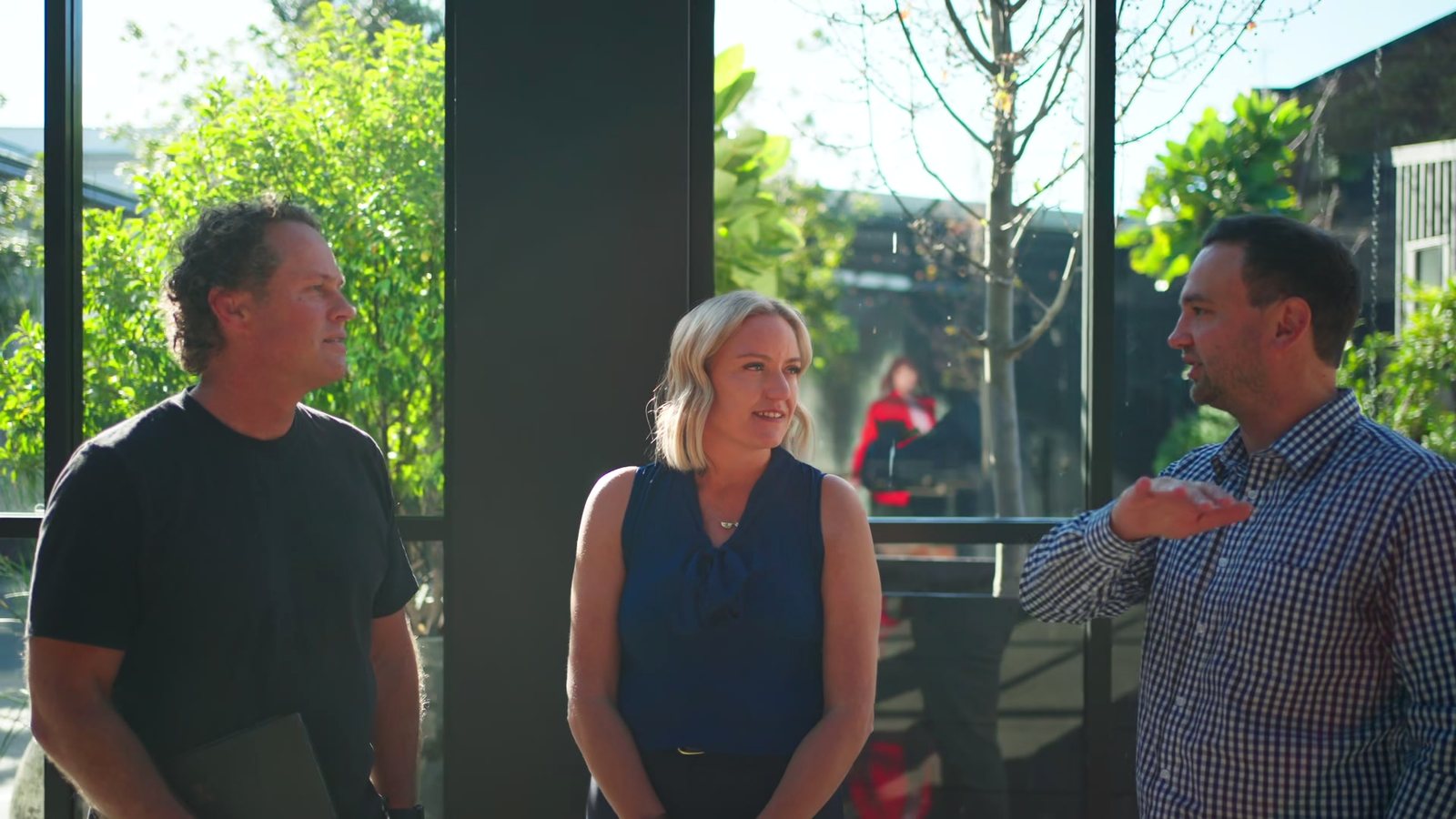 Matt, Mell and a client in conversation outside