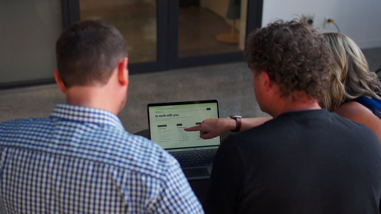 Over the shoulder: a client and Matt look at a screen together