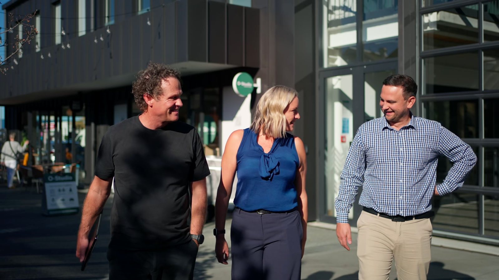 Matt, Mell and a client walking out of an office building